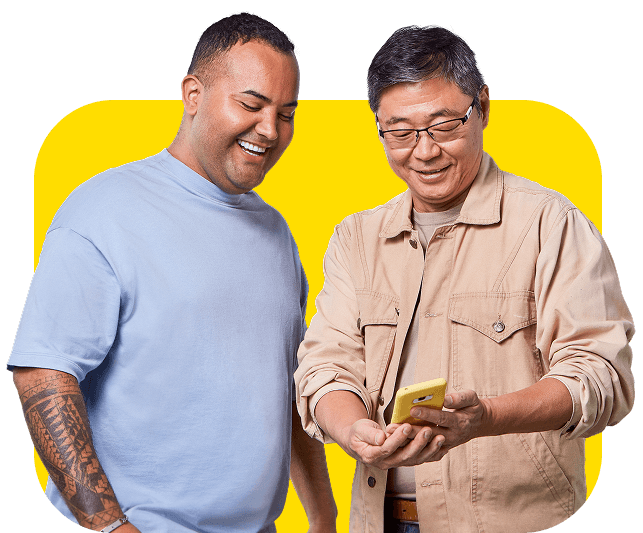 Two men smiling and seeing a phone.